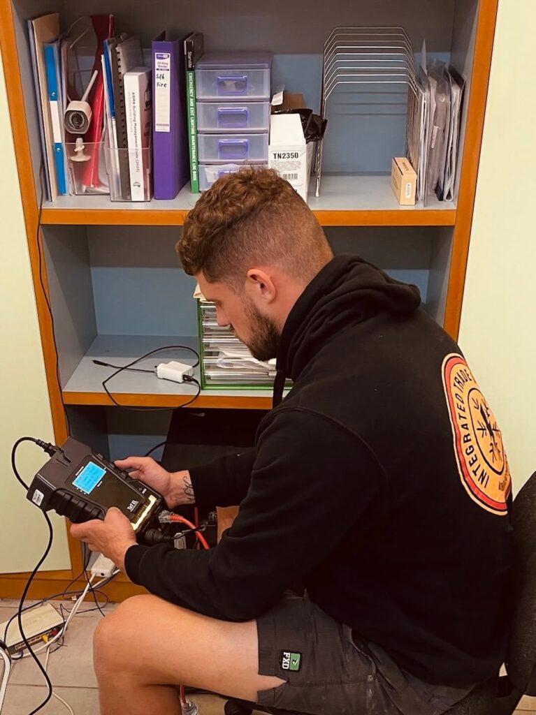 Brisbane electrician performing electrical safety checks and testing at a commercial property